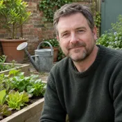 Man with short brown hair wearing a gardening jacket